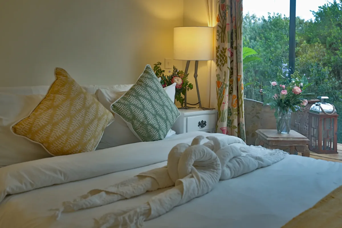 The bed turned down, lamplight and the forest beyond the window