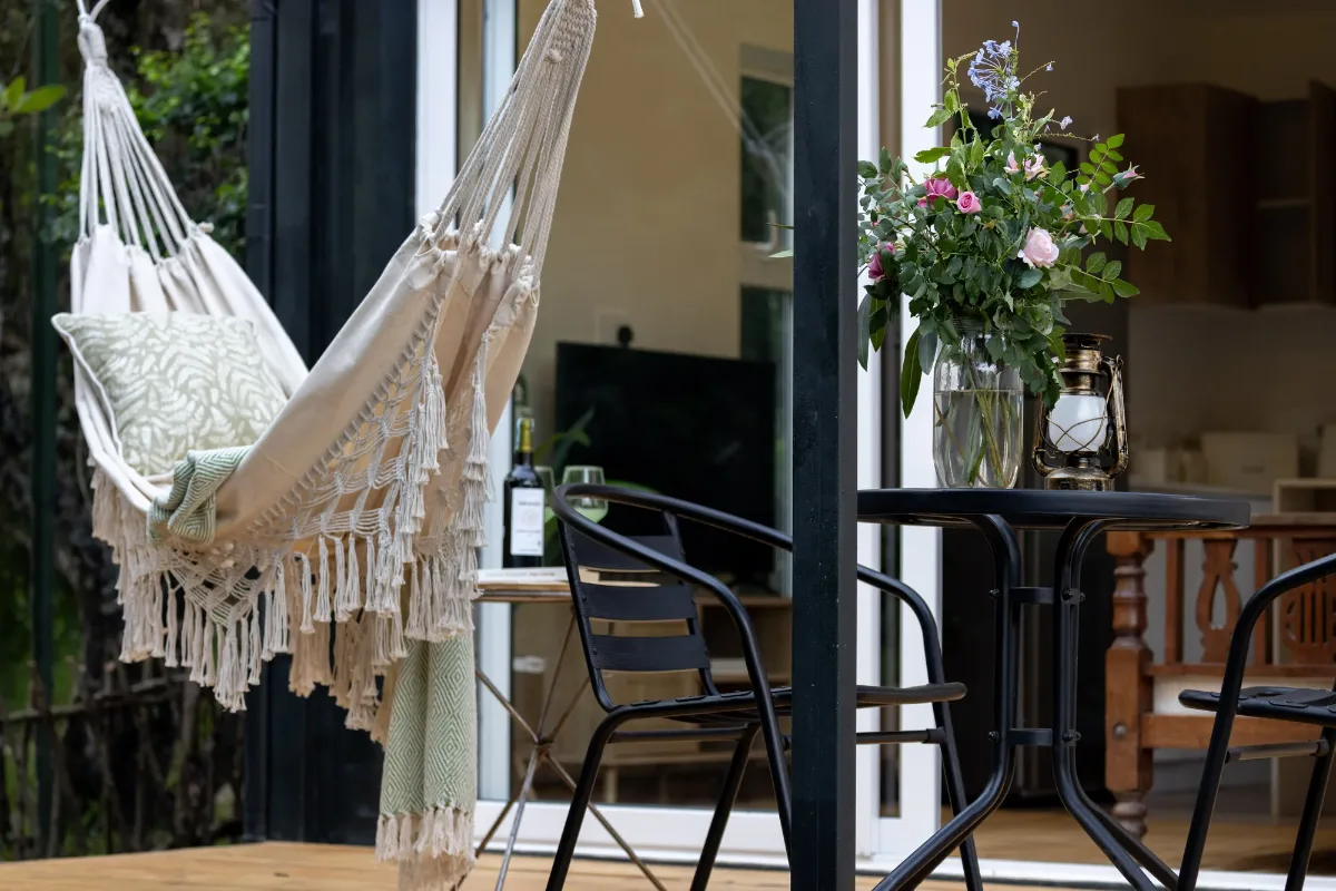 The hammock chair and bistro table on the deck