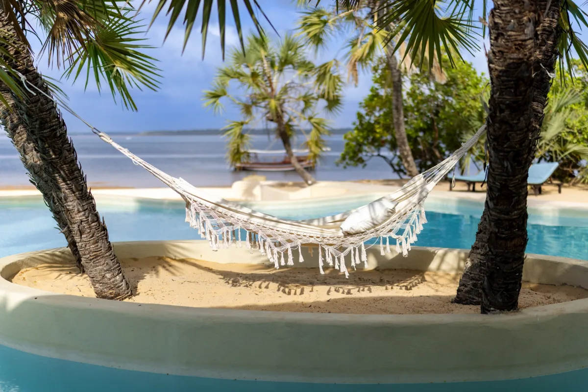 A hammock between the palms at The Cabanas Lamu